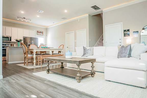 A modern kitchen with a dining table and chairs.