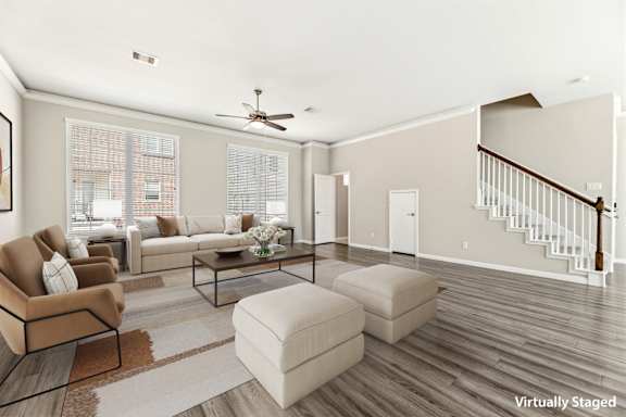 A living room with a brown chair, a white sofa, and a glass coffee table.