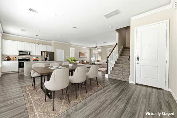 A modern kitchen with a dining table and chairs.