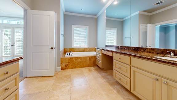 A kitchen with a white door and cabinets.