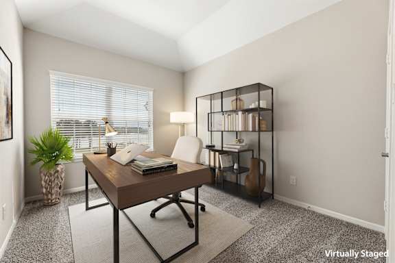 A room with a ceiling fan and carpeted floor.