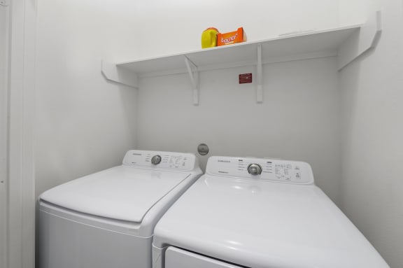 the laundry room is equipped with two washers and a dryer