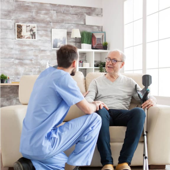 a man in a chair talking to a doctor