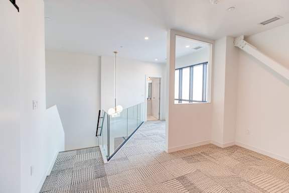 a large room with a glass floor and white walls