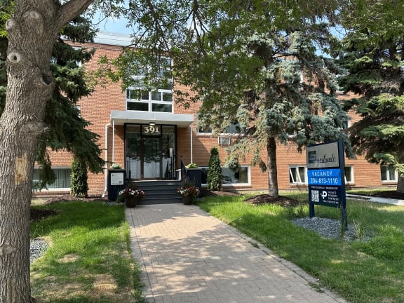a brick building with a sign in front of it