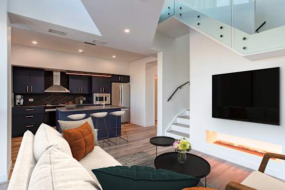 a living room with a couch and a kitchen