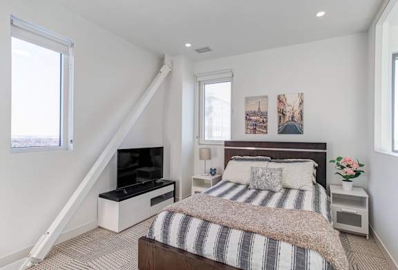 a bedroom with a bed and a tv