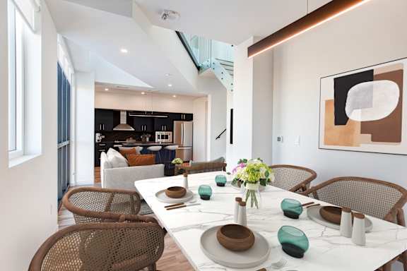 a dining room with a table and chairs and a living room