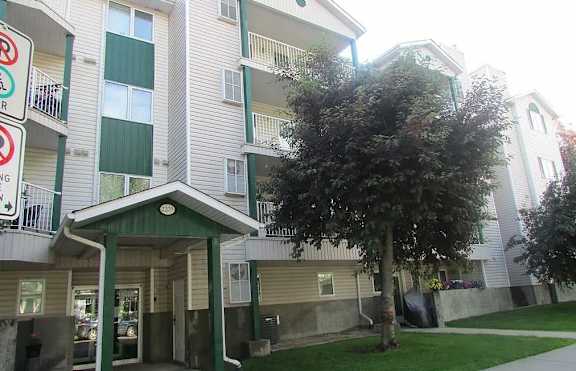 Apartment building with a no parking sign in front.