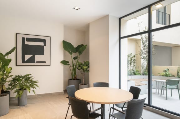 a dining room with a table and chairs and a large window