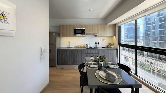 A dining area with a table set for two.