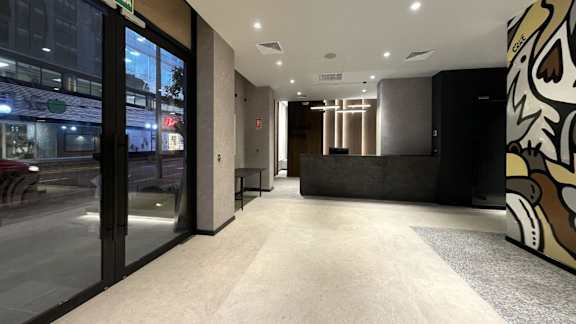 A hallway with a black and white mural on the right side.