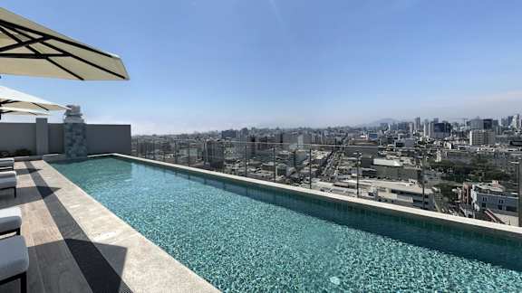 A swimming pool with a view of the city.