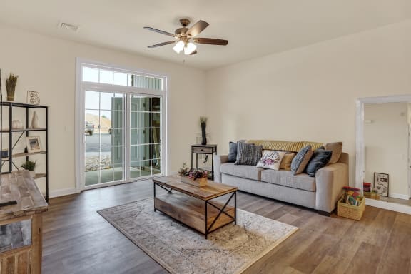 living room with hardwood floors and ceiling fan natural light  at Rowen Place Apartments, Hanover