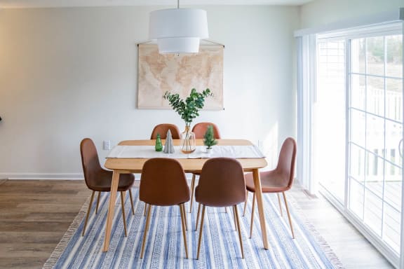 a look at the dining room featuring white walls and a blue and white striped rug at Legends Apartments, South Carolina, SC