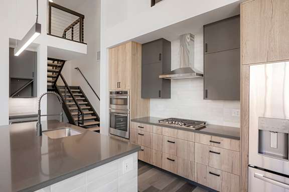 a kitchen with wooden cabinets and stainless steel appliances