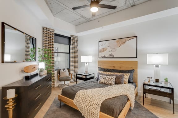 a bedroom with a bed and a dresser and a window