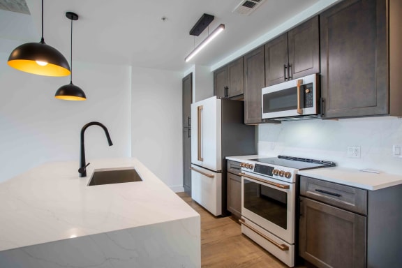 a kitchen with wooden cabinets and a white counter top