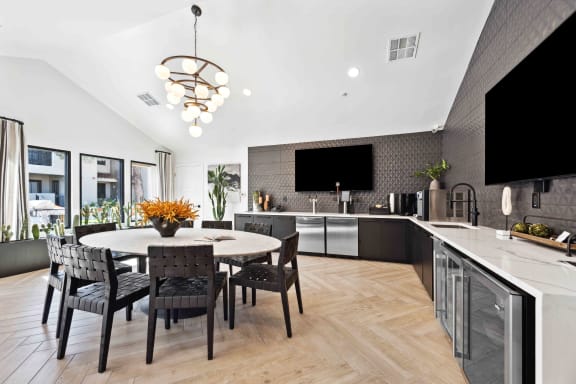 a kitchen and dining room with a table and chairs