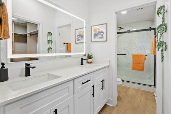A bathroom with a white sink and a mirror.