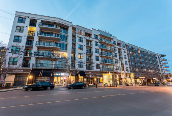 a large apartment building on a city street at night