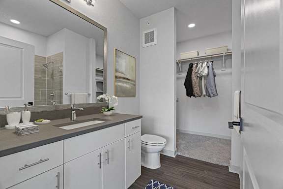 A bathroom with a white toilet and a white sink.