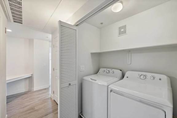 A white washer and dryer in a laundry room.