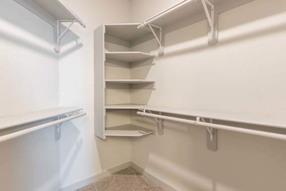 Empty white shelves in a pantry.