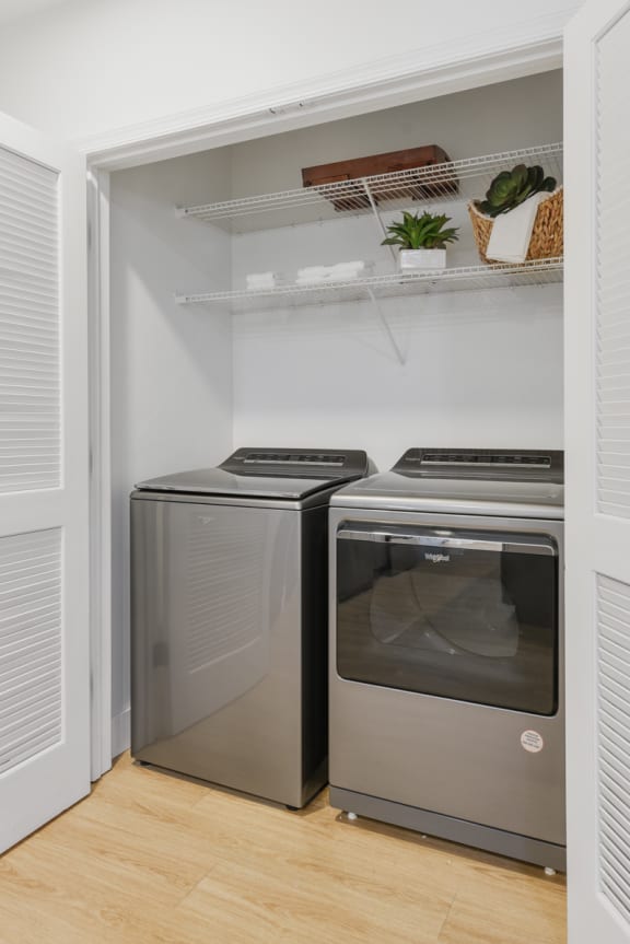 a small laundry room with two washes and a dryer