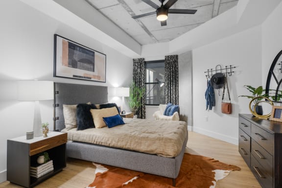 a bedroom with a bed and a ceiling fan