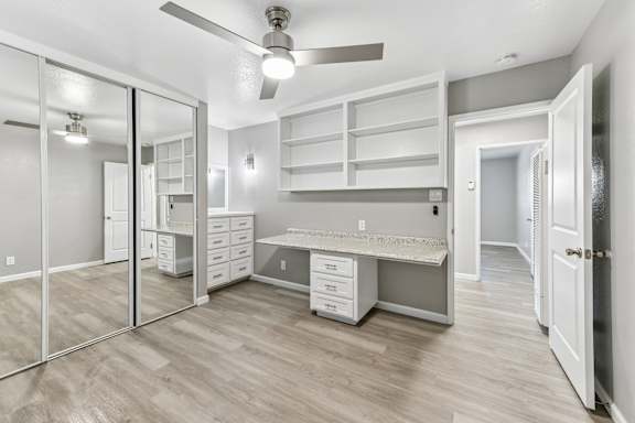 A spacious room with a desk and drawers.