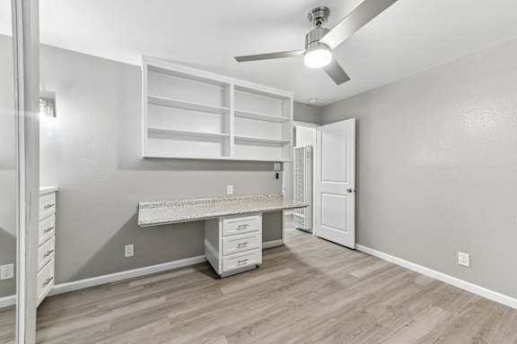A room with a desk and drawers in it.