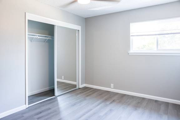 A room with a sliding door and a window.