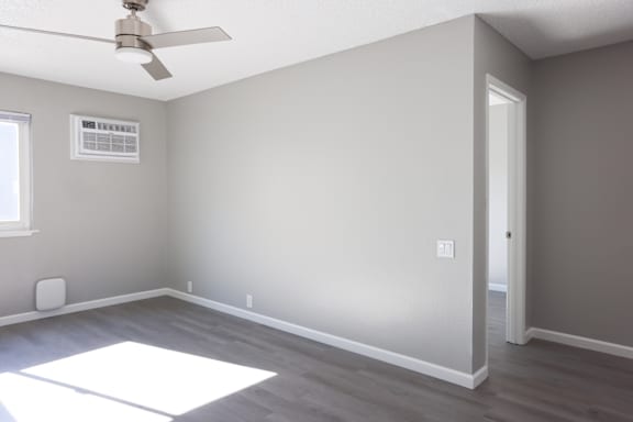 A room with a ceiling fan and a window.