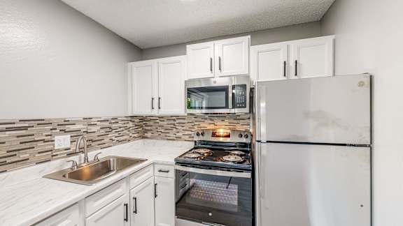 Updated Kitchen With White Appliances at University Square Apartments, California