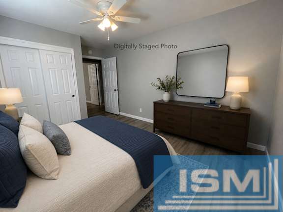 Staged bedroom with dresser mirror and navy bedding at OSM Properties Homes & Apartments, Chico, 95926
