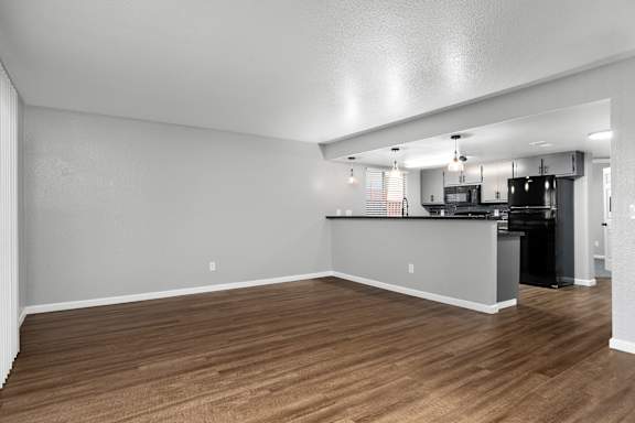 Open kitchen and living space with wood flooring at Redwood Cove Apartments, Chico, 95928