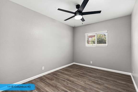 Vacant bedroom with gray walls and ceiling fan at OSM Properties Homes & Apartments, California