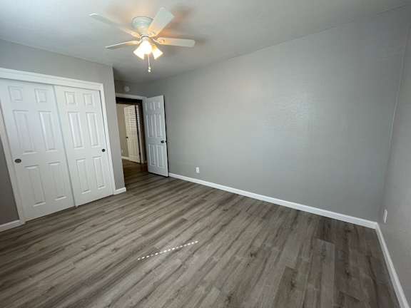 Empty bedroom with gray walls and ceiling fan at OSM Properties Homes & Apartments, California, 95926