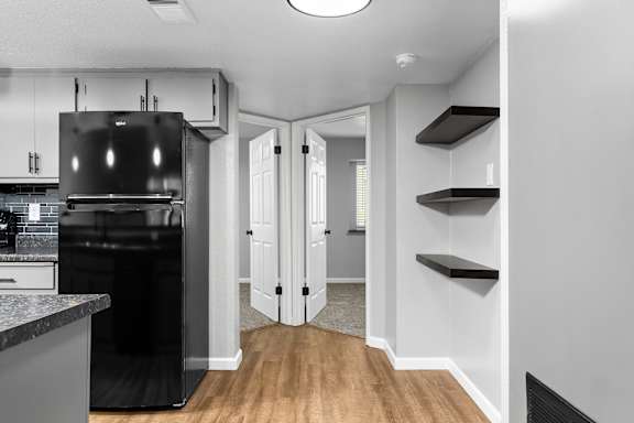 Kitchen hallway with floating shelves and double doors at Redwood Cove Apartments, Chico, 95928