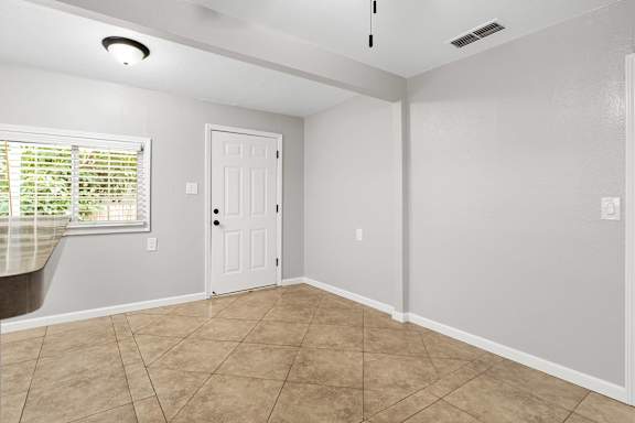 Entry area with tile flooring and white door at OSM Properties Homes & Apartments, Chico, 95926