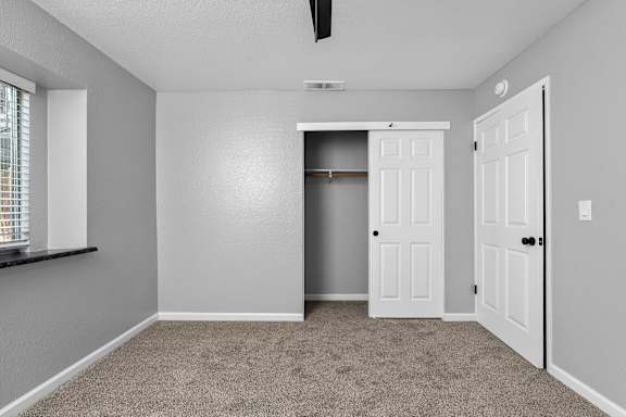 Empty bedroom with closet and vaulted ceiling at Redwood Cove Apartments, Chico, 95928