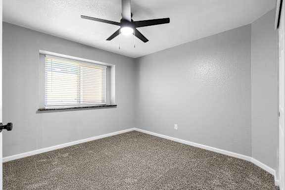 Spacious bedroom with carpet and ceiling fan at Redwood Cove Apartments, California, 95928