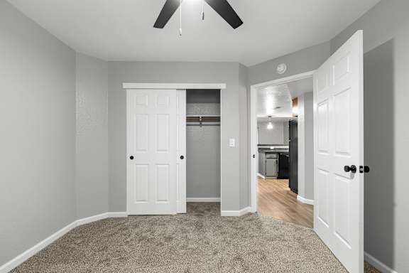 Bedroom with walk-in closet and ceiling fan at Redwood Cove Apartments, Chico, CA