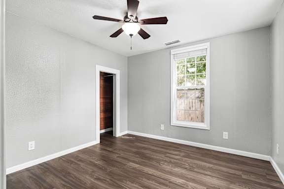 Empty bedroom with wood floors and vaulted ceiling at OSM Properties Homes & Apartments, California, 95926