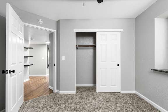 Bedroom with open closet and hardwood rod at Redwood Cove Apartments, Chico