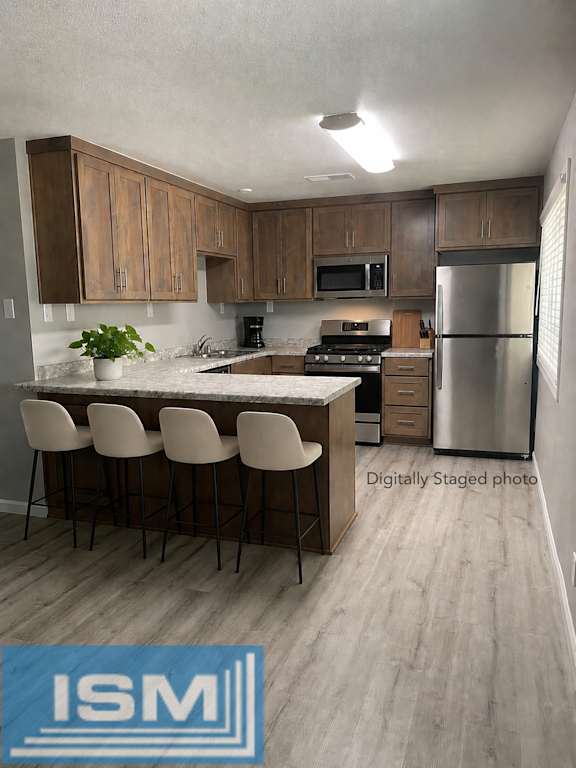 Kitchen island with bar seating and modern cabinetry at OSM Properties Homes & Apartments, Chico, CA 95926