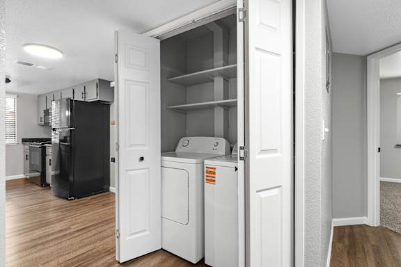 Laundry closet with washer and shelving storage at Redwood Cove Apartments, Chico, CA 95928