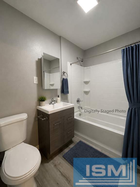 Updated bathroom with dark vanity and white subway tile at OSM Properties Homes & Apartments, Chico, California