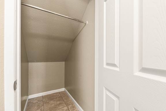 Walk-in closet with clothing rod at Cedar Park Apartments, California